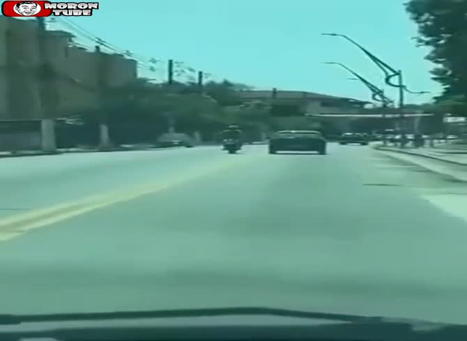Video :When a motorcycle rider hits an automobile, karma knocks him down